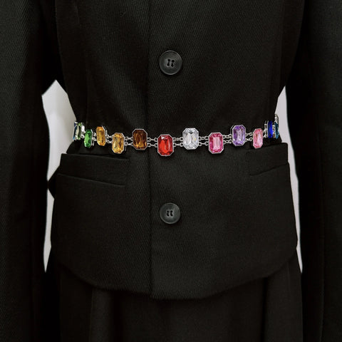Black coat with a colorful gemstone belt