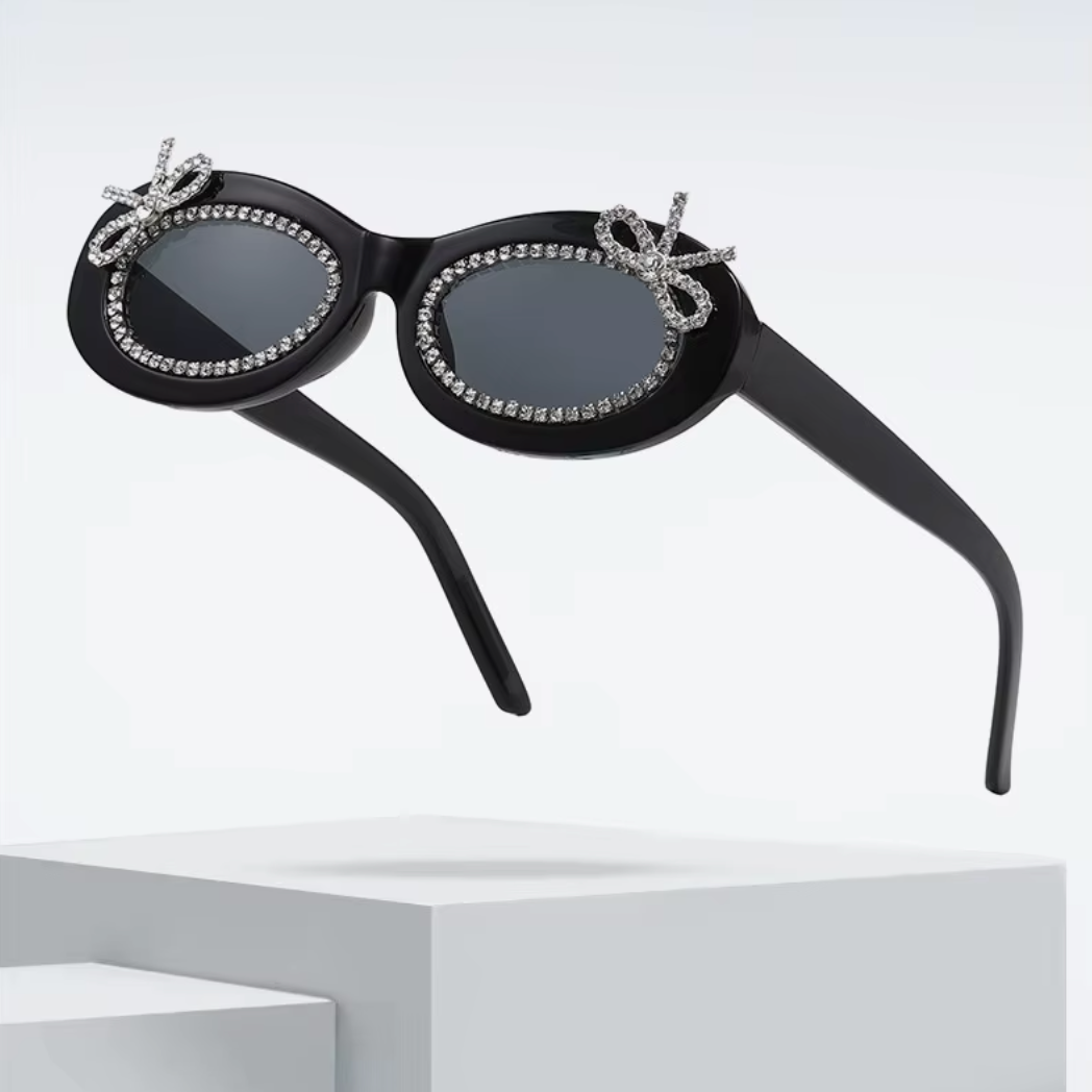 Black sunglasses with decorative elements on a white background