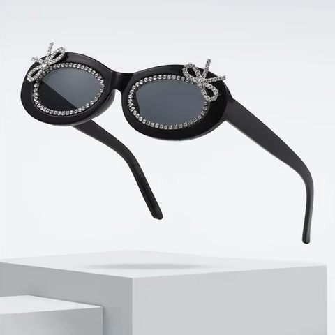 Black sunglasses with decorative elements on a white background