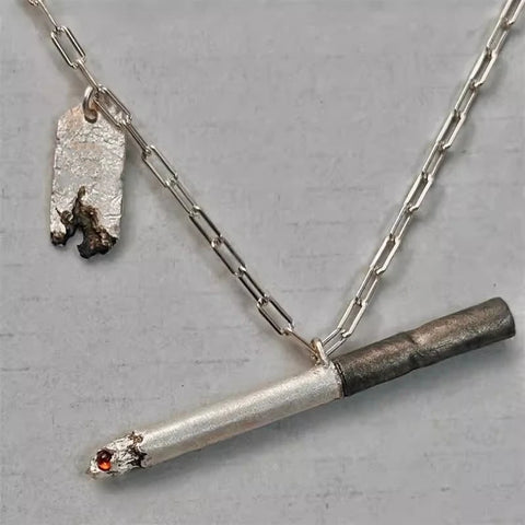 Silver necklace with a unique pendant on a gray background